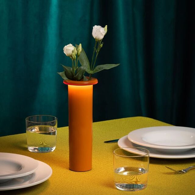 vase lamp against a velvet curtain